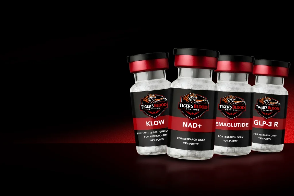 Four bottles of Tiger's Blood Peptides for research with red caps, arranged on a dark background; labels read KLOW, NAD+, EMAGLUTIDE, and GLP-3 R.